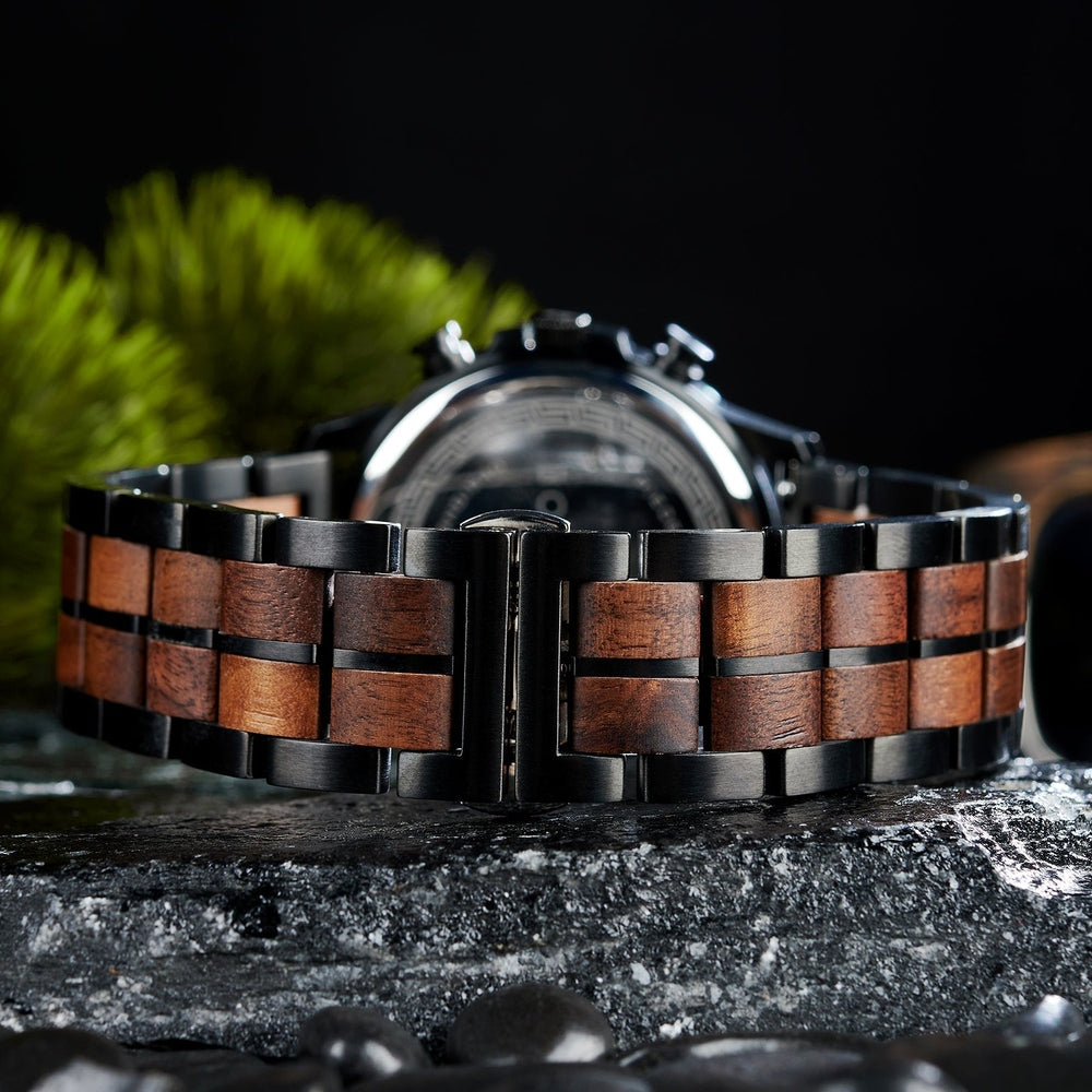 Close-up of Mokozai wooden watch strap with metal accents, highlighting the intricate wood grain and polished black links.