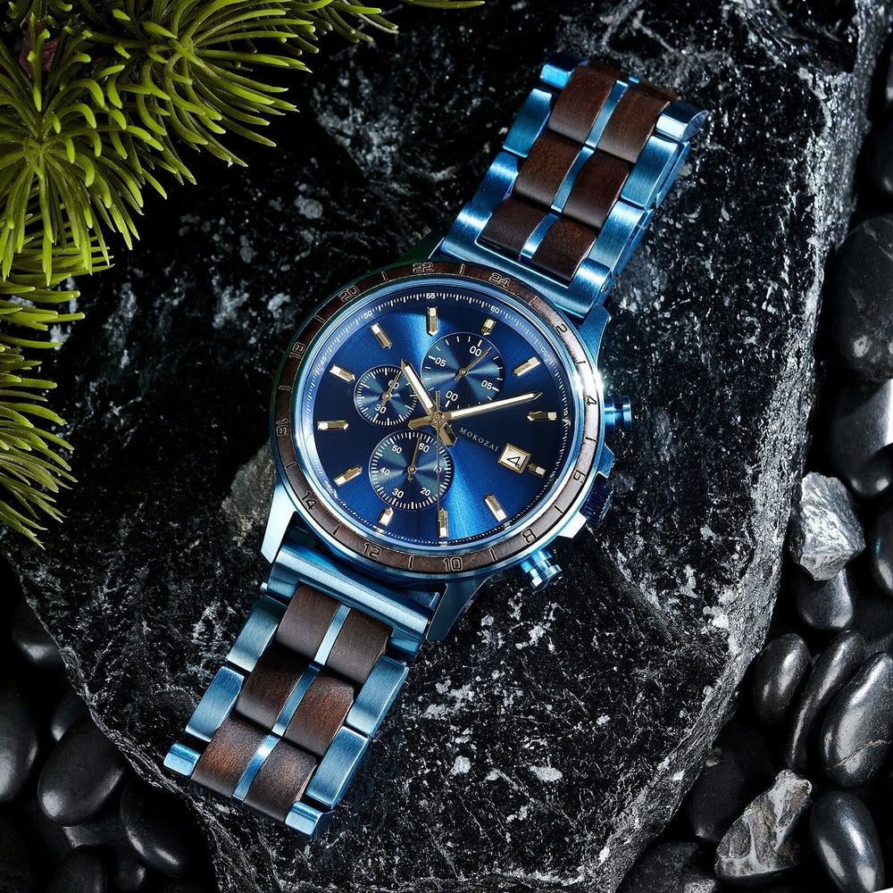 Mokozai luxury men's watch with a striking blue dial and wood-accented stainless steel bracelet, displayed on a black stone surface. The bold color combination and intricate chronograph details make it the perfect sophisticated accessory for stylish Australians.