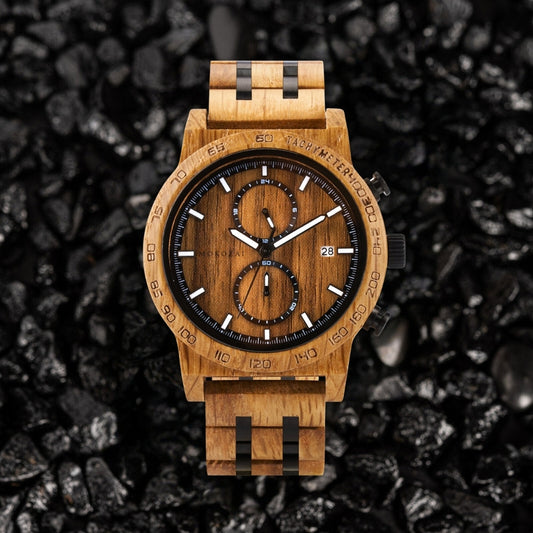 Mokozai wooden wristwatch with a rich brown wood grain finish, black subdials, and white markers, featuring a tachymeter bezel, displayed on a textured black stone background.